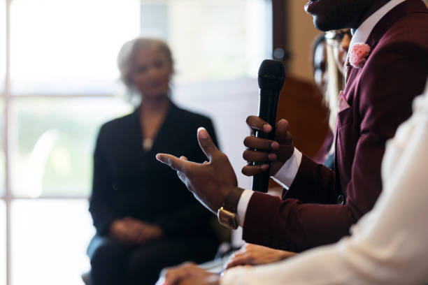 Pictured: Man with microphone speaking