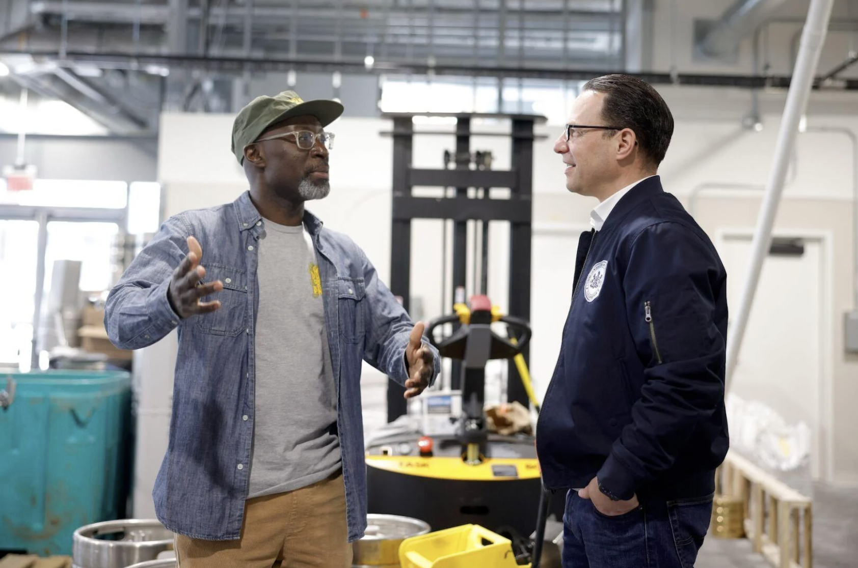 Mengistu Koilor, owner of Two Locals Brewing Co., speaks with Gov. Josh Shapiro during a Thursday, Feb. 15, visit to the business.