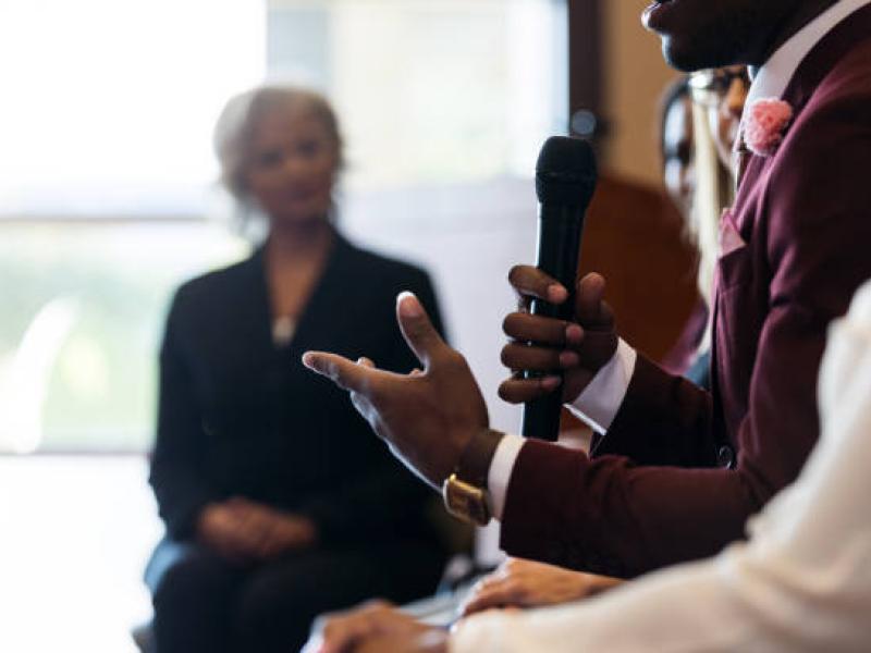 Pictured: Man with microphone speaking
